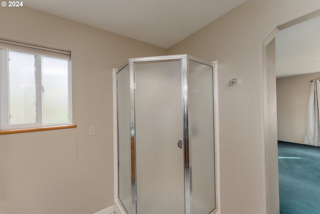 bathroom featuring plenty of natural light and walk in shower