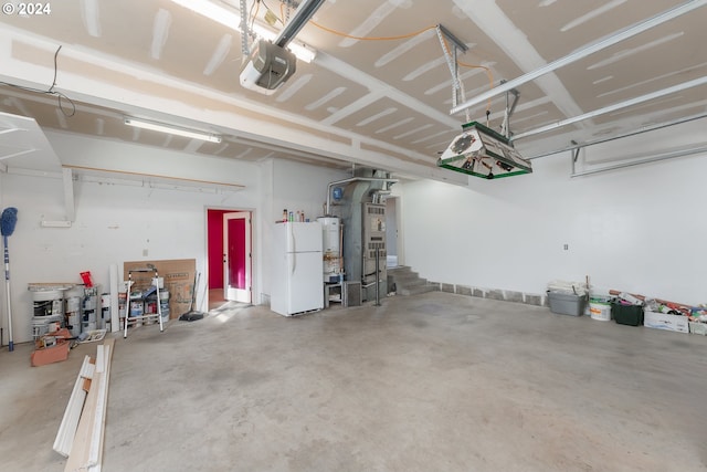 garage featuring a garage door opener, water heater, and white fridge