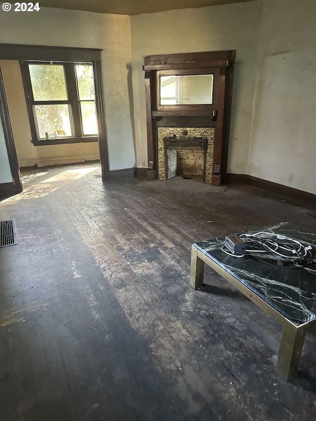 unfurnished living room with wood-type flooring and a fireplace