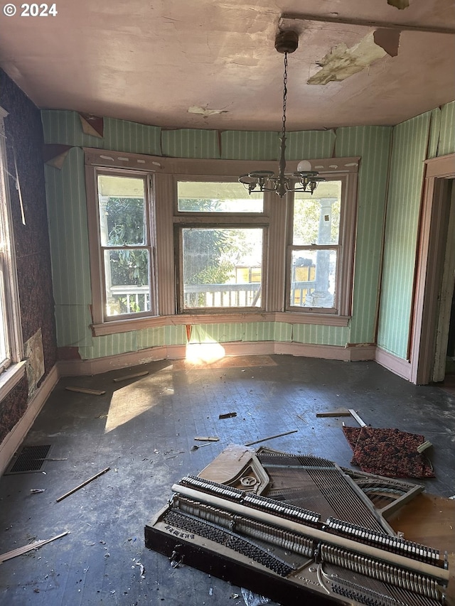 unfurnished room with a chandelier