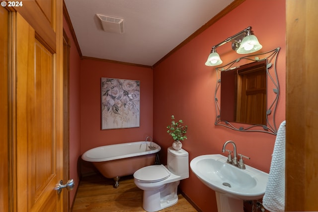 bathroom with hardwood / wood-style floors, sink, a bathtub, ornamental molding, and toilet