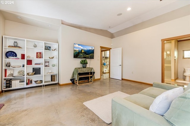 living room featuring vaulted ceiling and concrete floors