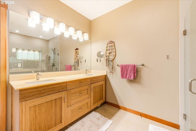 bathroom with vanity and a shower with door