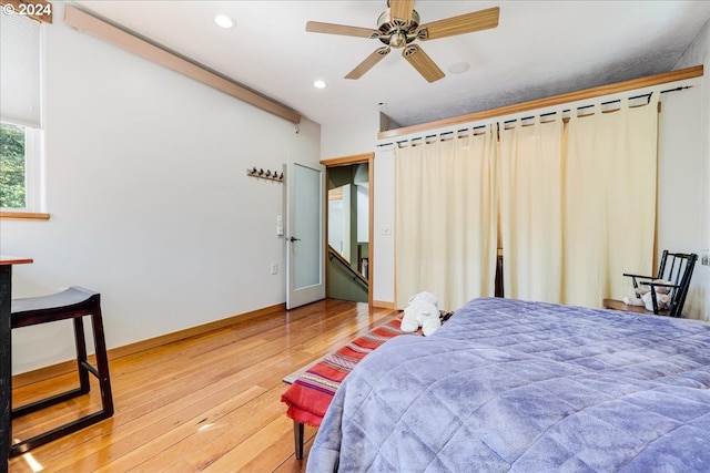 bedroom with hardwood / wood-style floors and ceiling fan