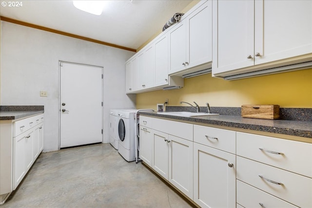 washroom featuring washer and clothes dryer, cabinets, crown molding, and sink