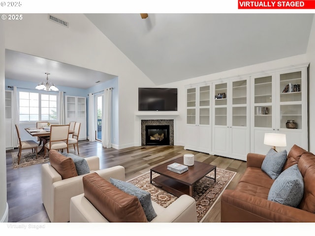 870 Kristen Way, Cottage Grove, OR 97424 - living room with a glass covered fireplace, visible vents, a notable chandelier, and wood finished floors