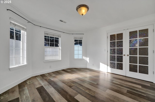 unfurnished room featuring wood-type flooring and french doors