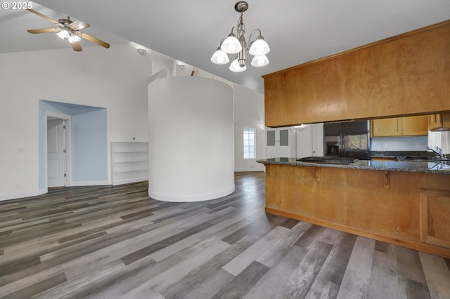 kitchen with stainless steel fridge with ice dispenser, sink, decorative light fixtures, kitchen peninsula, and dark hardwood / wood-style flooring