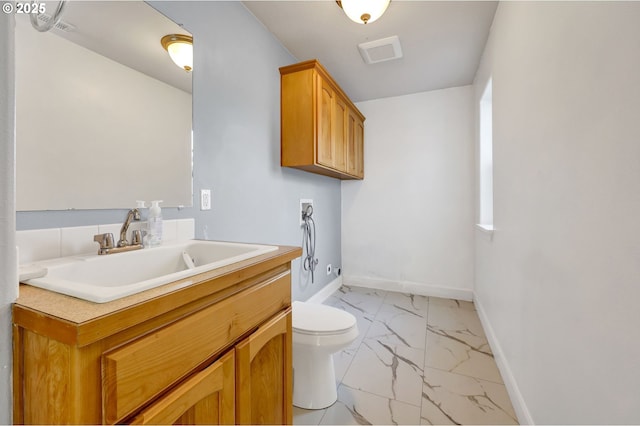 870 Kristen Way, Cottage Grove, OR 97424 - bathroom featuring visible vents, baseboards, toilet, marble finish floor, and vanity