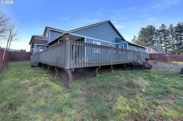 back of house with a yard and a deck