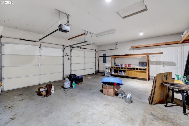 garage with a garage door opener and electric panel