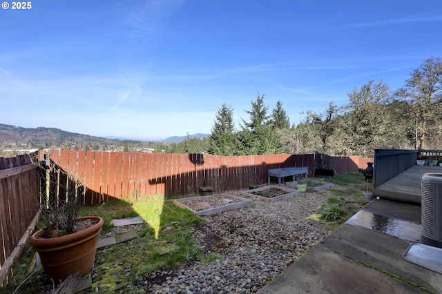 870 Kristen Way, Cottage Grove, OR 97424 - view of yard with a fenced backyard, a mountain view, and a vegetable garden