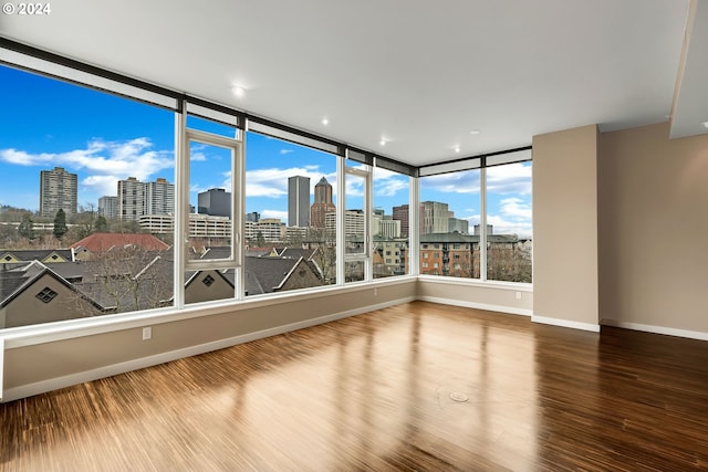 unfurnished room with wood-type flooring