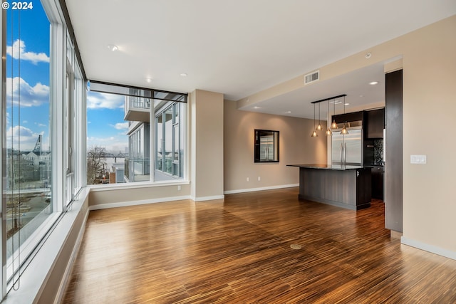 unfurnished living room featuring dark wood-type flooring