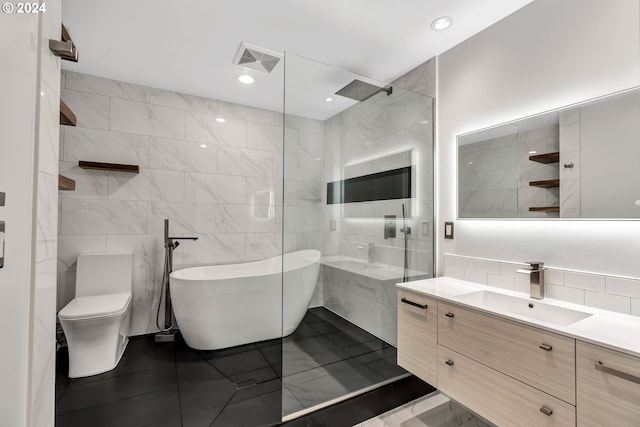 bathroom with toilet, vanity, a bath to relax in, tile walls, and tile flooring