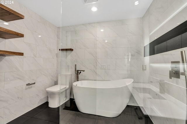 bathroom with tile flooring, toilet, and tile walls