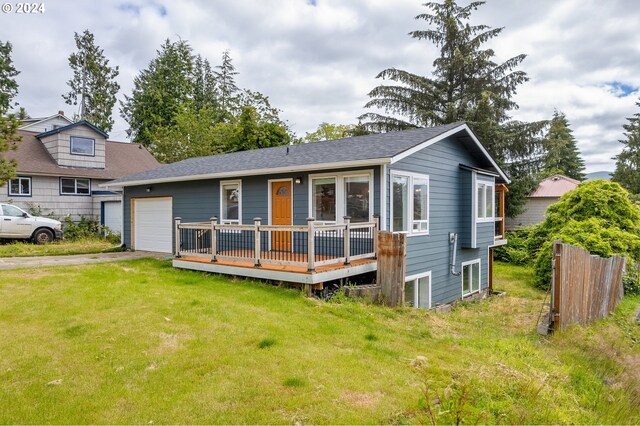 view of front of property with a front yard and a garage