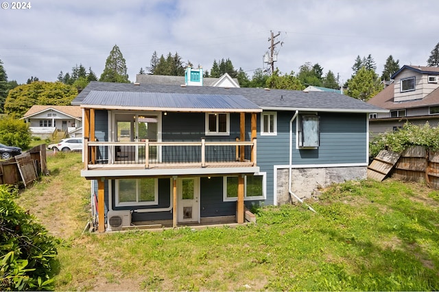 back of house featuring ac unit and a yard