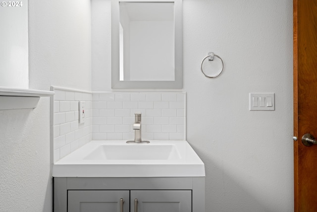 bathroom with decorative backsplash and vanity