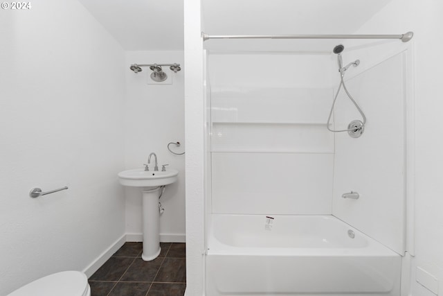 bathroom featuring tile patterned flooring, toilet, and bathing tub / shower combination