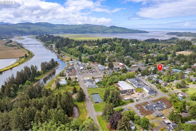 drone / aerial view featuring a water and mountain view