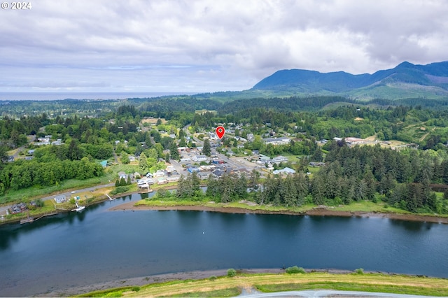 drone / aerial view featuring a water and mountain view