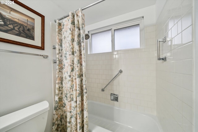 bathroom with toilet and shower / bath combo with shower curtain