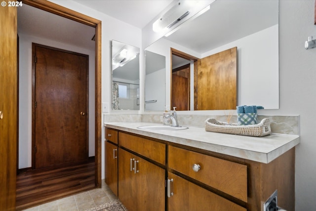 bathroom with vanity and hardwood / wood-style flooring