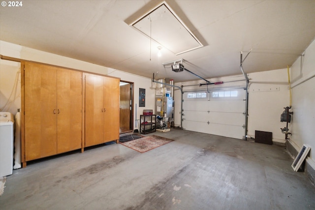 garage featuring water heater, electric panel, and a garage door opener