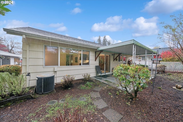 rear view of property featuring cooling unit