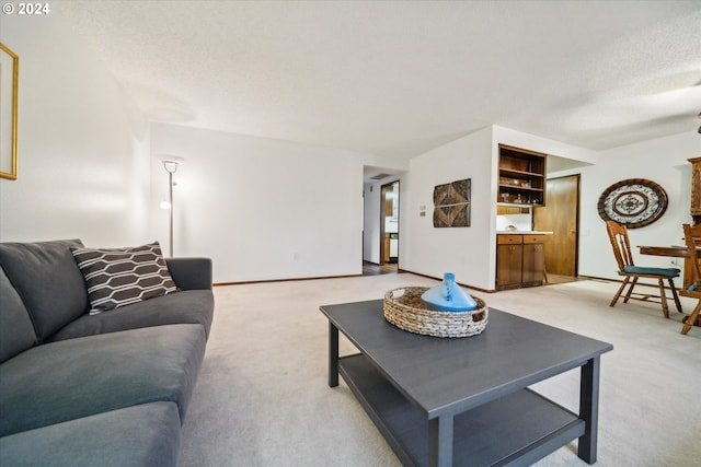 carpeted living room featuring a textured ceiling