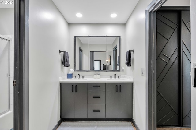 bathroom featuring walk in shower and vanity