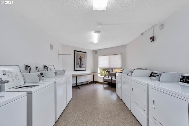 laundry room with separate washer and dryer, a textured ceiling, and baseboard heating