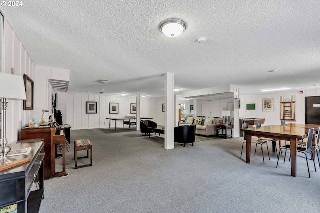 living room with light colored carpet and a textured ceiling