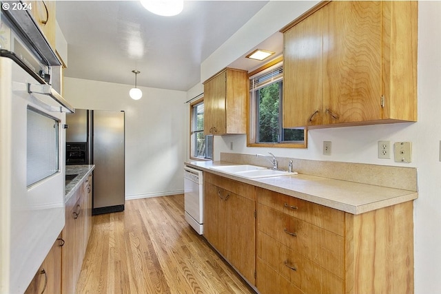 kitchen featuring stainless steel fridge with ice dispenser, white dishwasher, light hardwood / wood-style flooring, sink, and decorative light fixtures