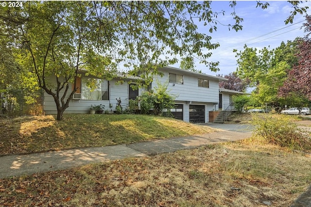 view of front of property with a front yard and a garage