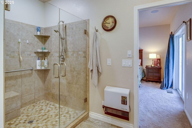 191 SW 67th St, Redmond, OR 97756 - bathroom with heating unit, visible vents, a stall shower, and connected bathroom