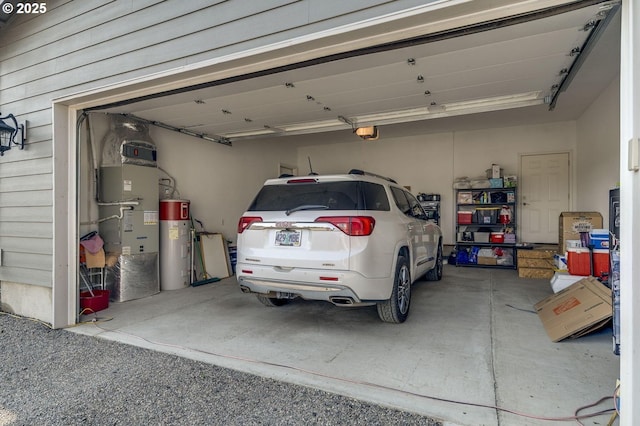 191 SW 67th St, Redmond, OR 97756 - garage featuring a garage door opener, heating unit, and water heater