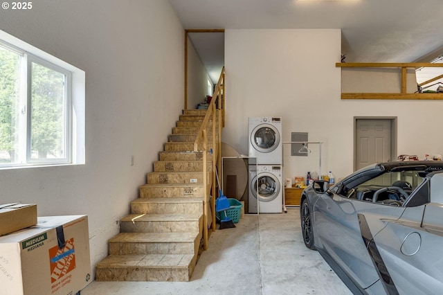191 SW 67th St, Redmond, OR 97756 - stairs featuring stacked washing maching and dryer and a wealth of natural light