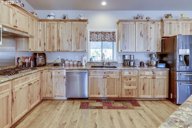 191 SW 67th St, Redmond, OR 97756 - kitchen with light brown cabinetry, a sink, light wood-style floors, stainless steel appliances, and under cabinet range hood
