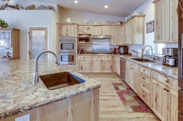 191 SW 67th St, Redmond, OR 97756 - kitchen with light brown cabinetry, stainless steel appliances, a sink, and light wood-style floors