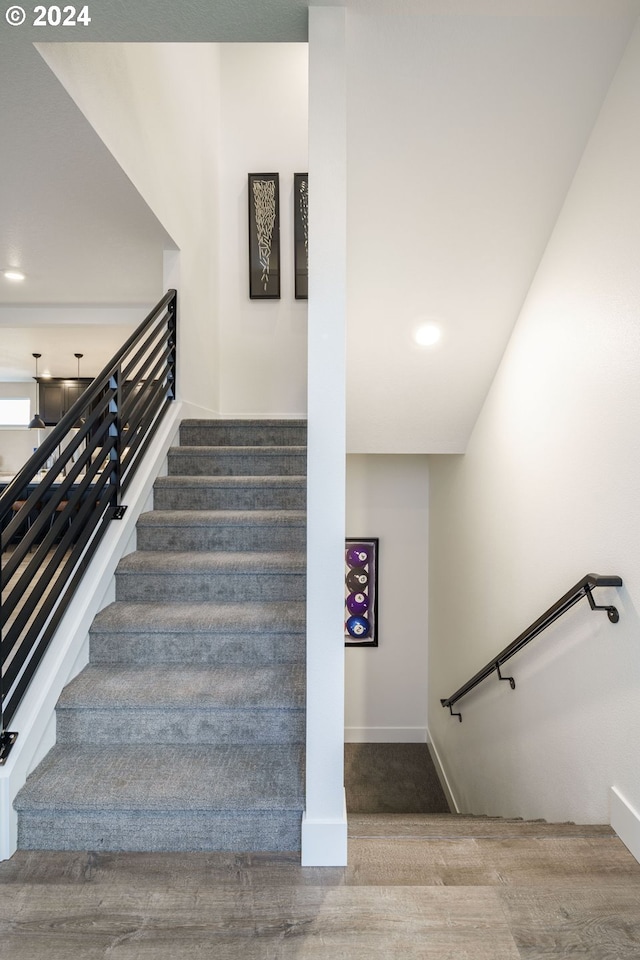 stairway featuring wood-type flooring