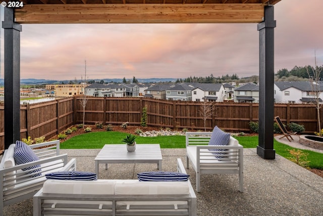 patio terrace at dusk featuring an outdoor living space with a fire pit