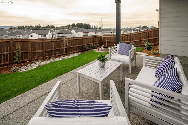 patio terrace at dusk with a lawn and an outdoor hangout area