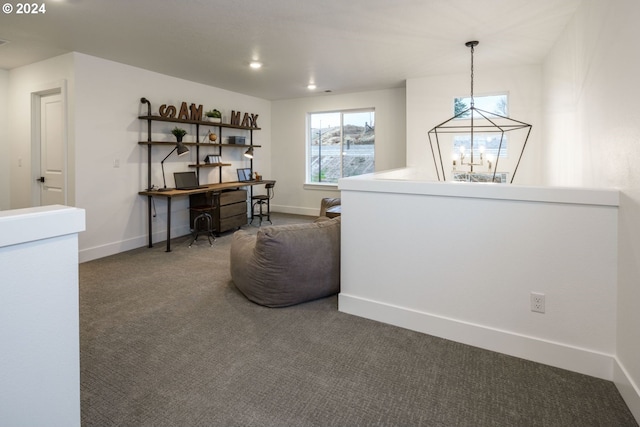 living area with an inviting chandelier and carpet flooring