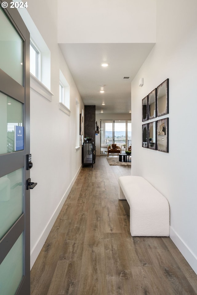 hallway with hardwood / wood-style floors