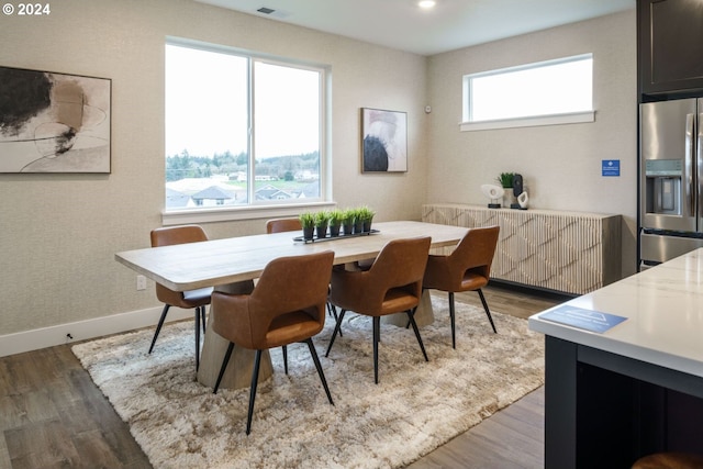 dining space featuring a wealth of natural light and hardwood / wood-style flooring