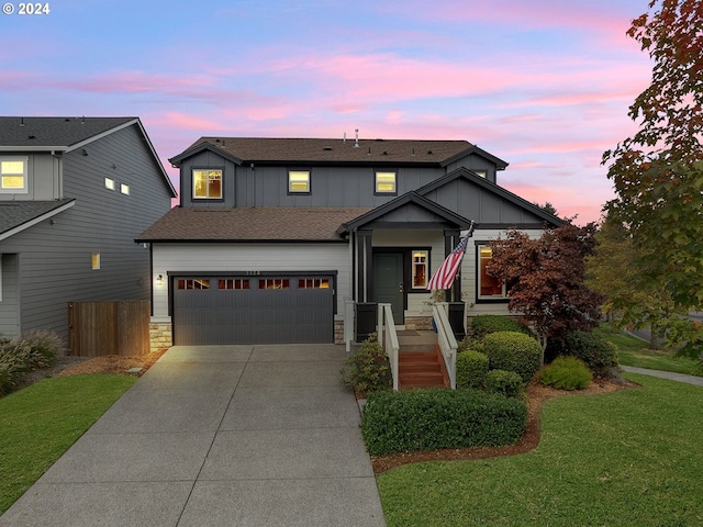 craftsman house with a garage and a yard