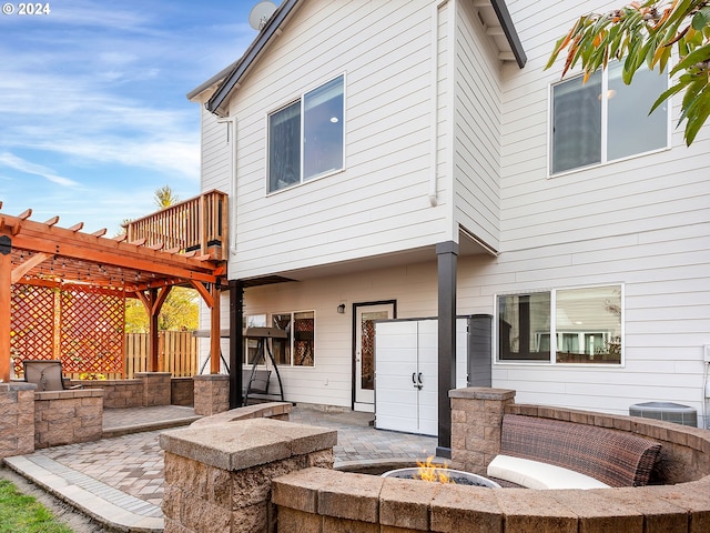 back of property featuring a fire pit, a patio area, and a pergola