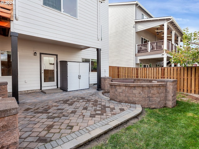 view of patio featuring ceiling fan and a balcony